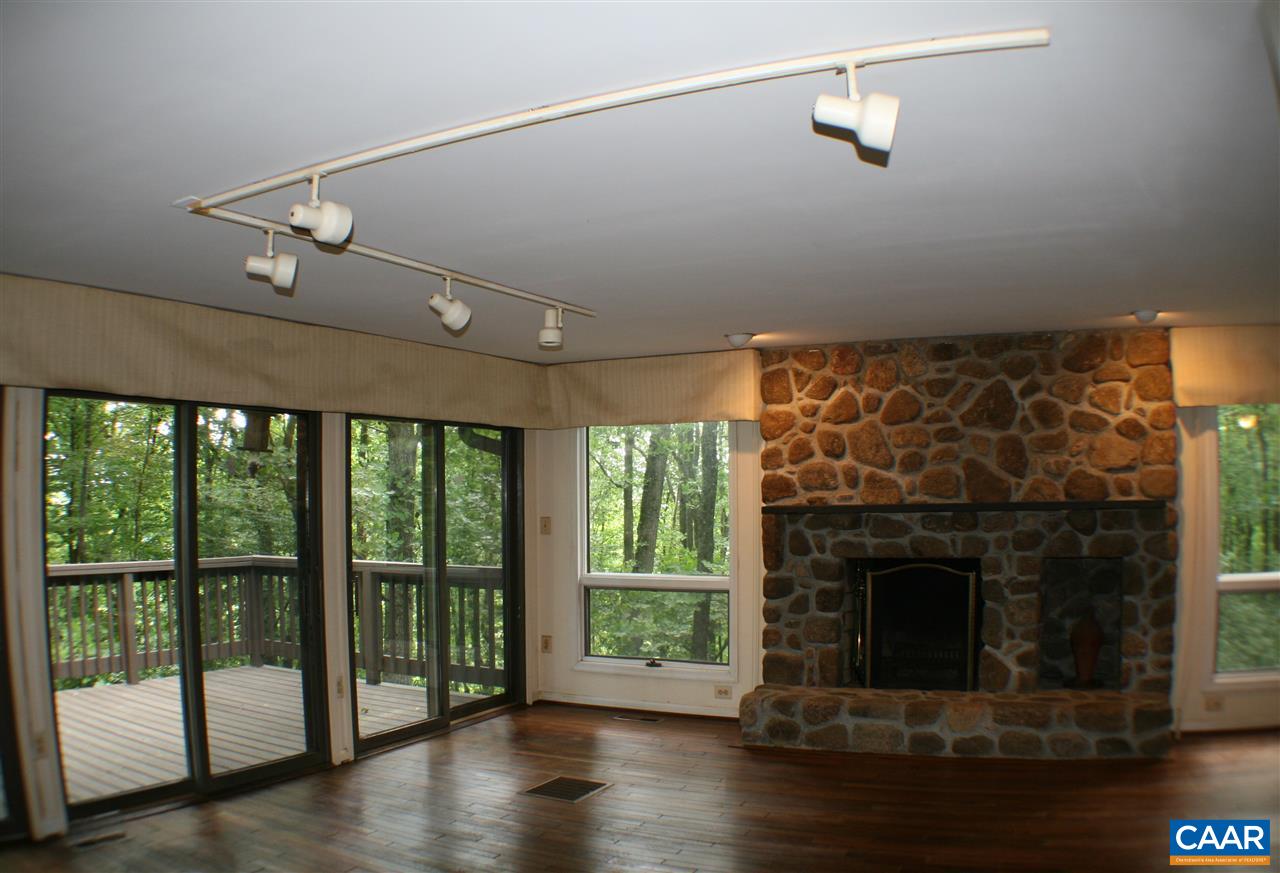 529 Blankenbaker Road Madison, VA 22727 - Photo 2 of 10 a living room with a fireplace and a floor to ceiling window