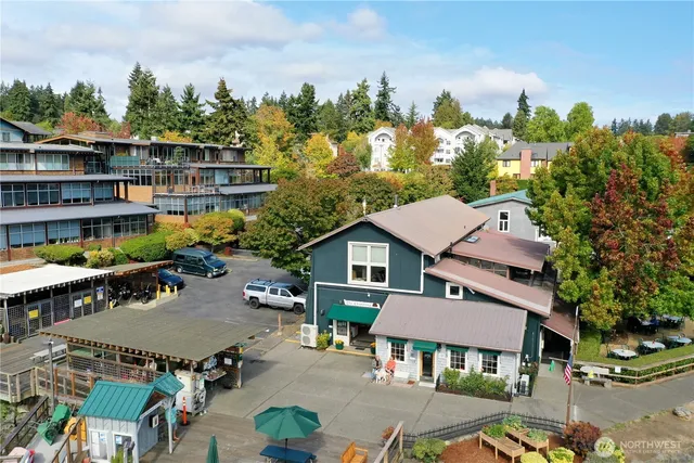 an aerial view of a house with swimming pool and furniture