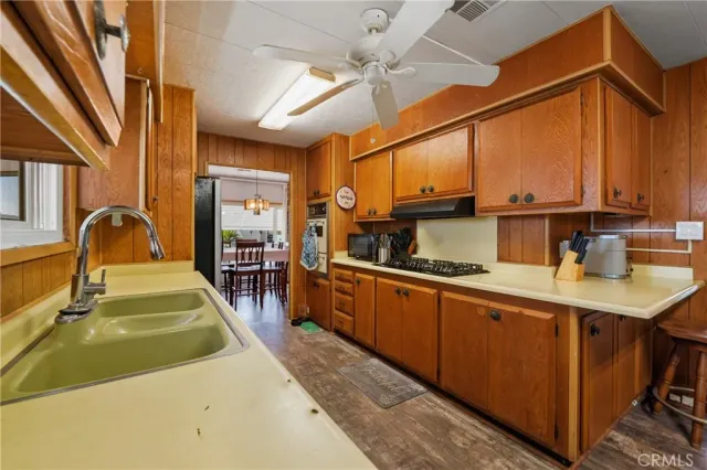 a kitchen with sink a refrigerator and cabinets