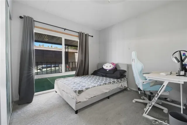 a bedroom with a bed and large window