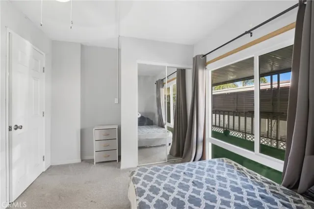 a bedroom with a bed and a large window