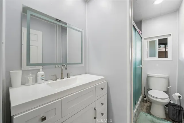 a white toilet sitting next to a bathroom sink