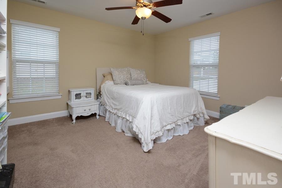220 Orkney Road Stem, NC 27581 - Photo 11 of 18 a spacious bedroom with a bed and a chandelier