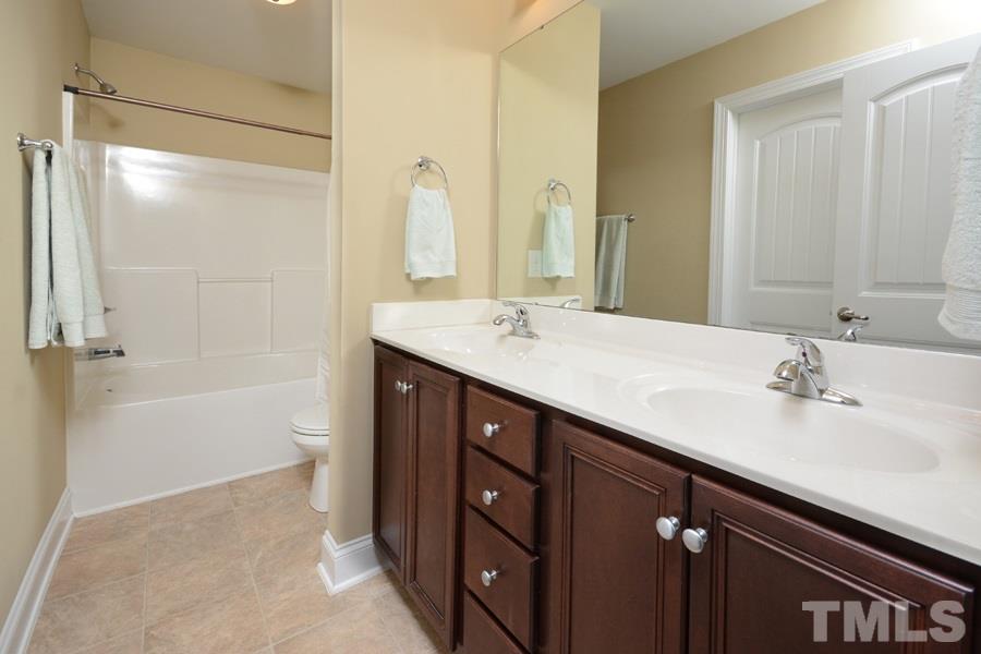 220 Orkney Road Stem, NC 27581 - Photo 12 of 18 a bathroom with a sink double vanity granite tub shower and a mirror