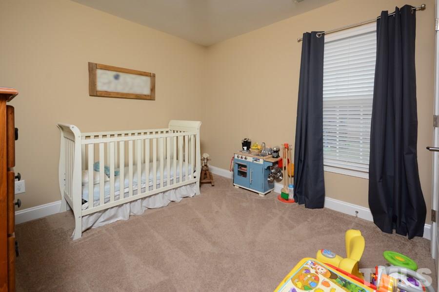 220 Orkney Road Stem, NC 27581 - Photo 14 of 18 a view of a bedroom with workspace and a window