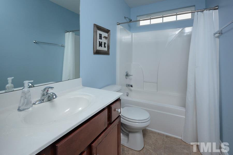 220 Orkney Road Stem, NC 27581 - Photo 15 of 18 a bathroom with a sink a toilet and shower