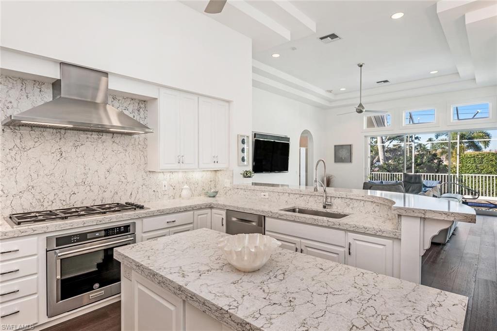2540 Half Moon Walk Naples, FL 34102 - Photo 15 of 44 a kitchen with stainless steel appliances a sink stove and cabinets