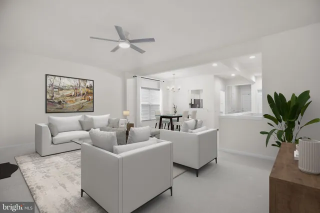 a bedroom with a bed ceiling fan and a window