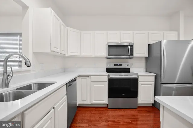 a front view of a house with plants