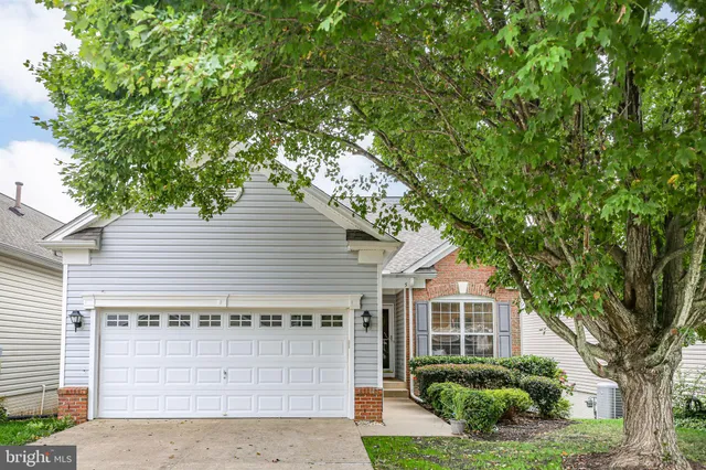 a view of backyard with swimming pool and seating
