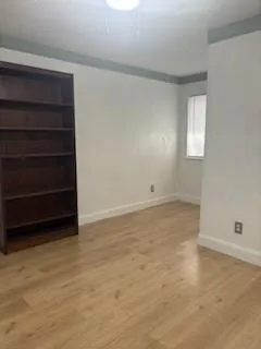 a view of an empty room with a cabinet