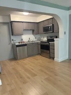 a kitchen with stainless steel appliances a sink and a stove