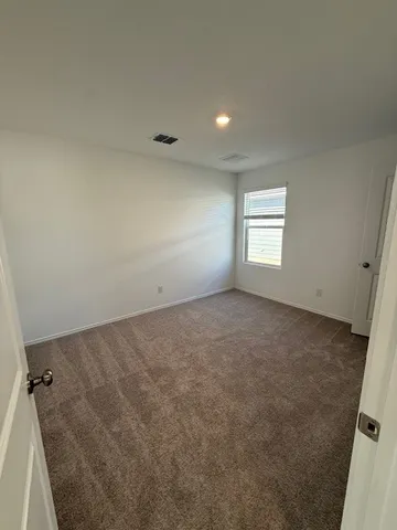 an empty room with a empty space and windows