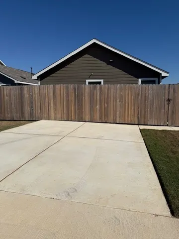 a front view of a house with a wooden fence