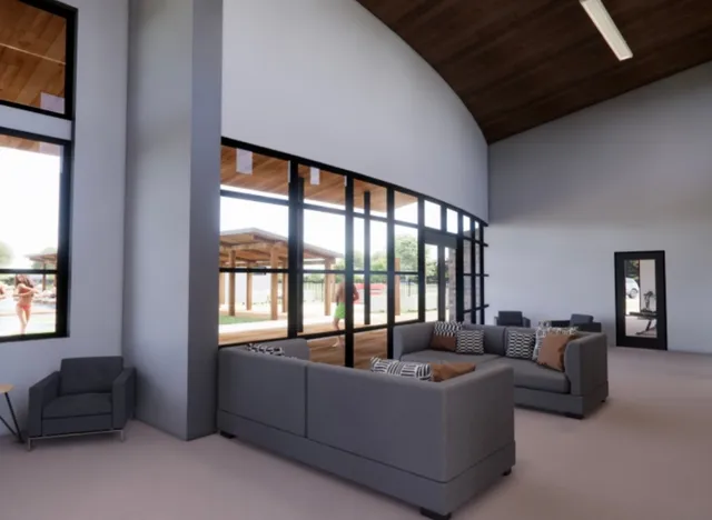 a living room with furniture a window and gym equipment