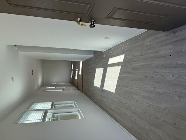 216 Sormonne Loop Kyle, TX 78640 - Photo 3 of 29 wooden floor in a hall with an entryway