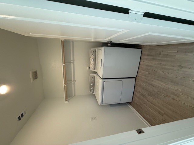 216 Sormonne Loop Kyle, TX 78640 - Photo 4 of 29 a utility room with a washer dryer and wooden floor