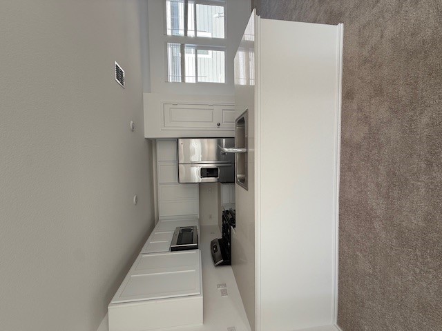 216 Sormonne Loop Kyle, TX 78640 - Photo 5 of 29 a view of kitchen with stainless steel appliances granite countertop a refrigerator a sink a stove a microwave and cabinets