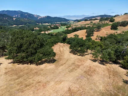 an aerial view of mountain with residential space and mountain view in back