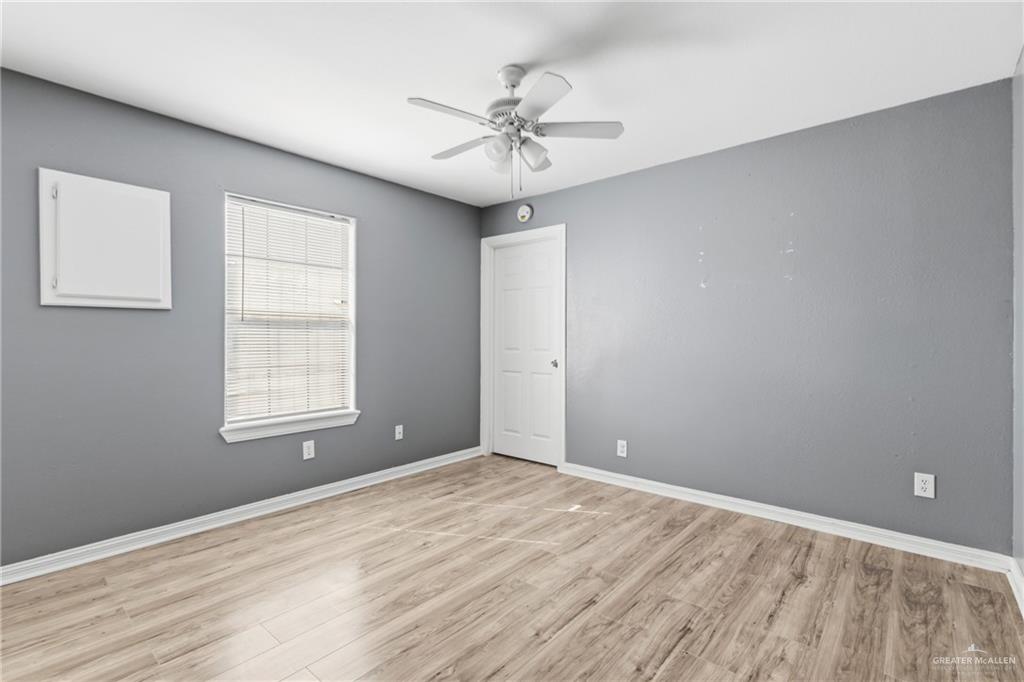 1918 Angus Street, Unit 2 Mission, TX 78572 - Photo 13 of 18 wooden floor in an empty room with a window