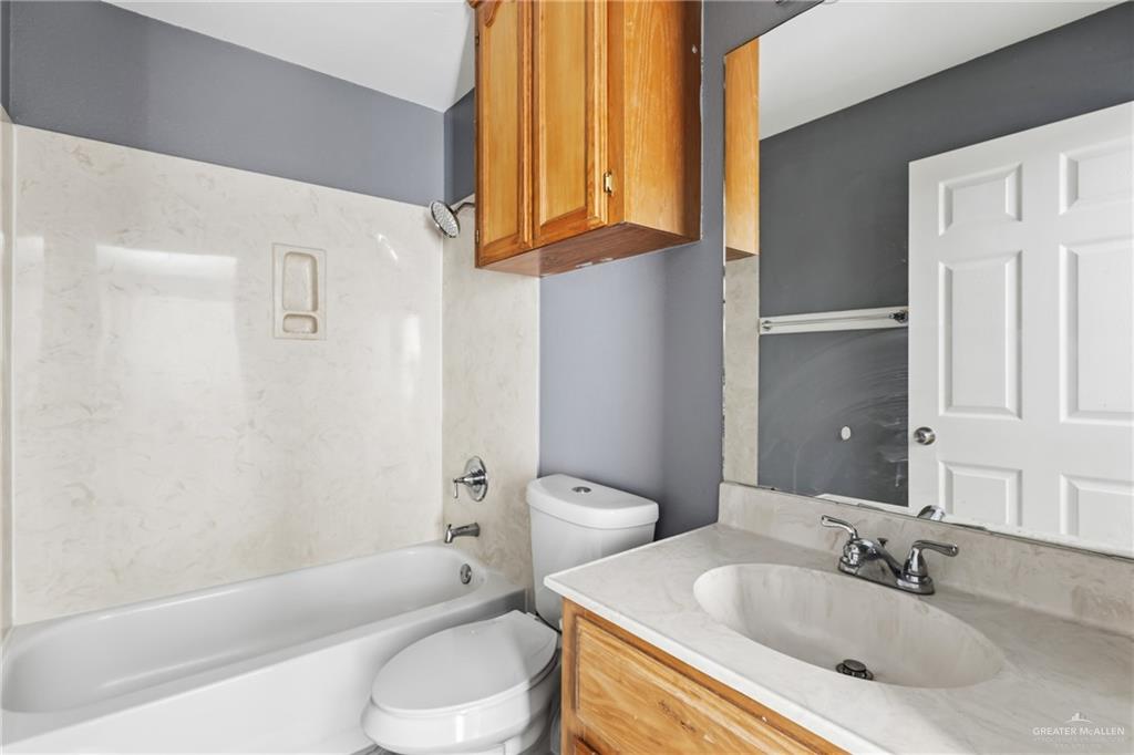 1918 Angus Street, Unit 2 Mission, TX 78572 - Photo 14 of 18 a bathroom with a sink toilet and shower
