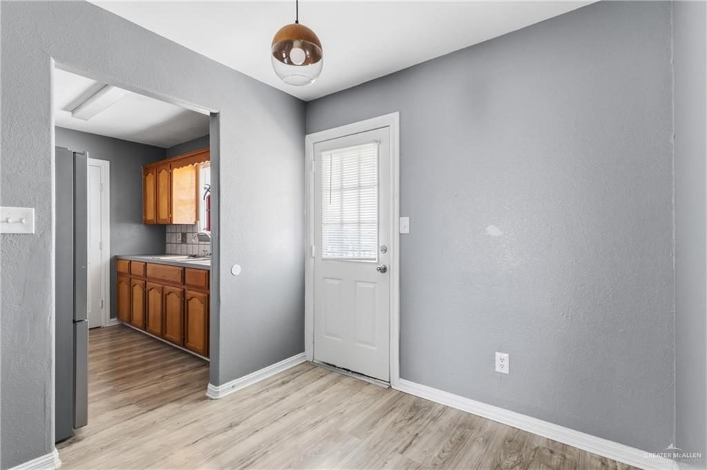1918 Angus Street, Unit 2 Mission, TX 78572 - Photo 15 of 18 wooden floor in an empty room with a window