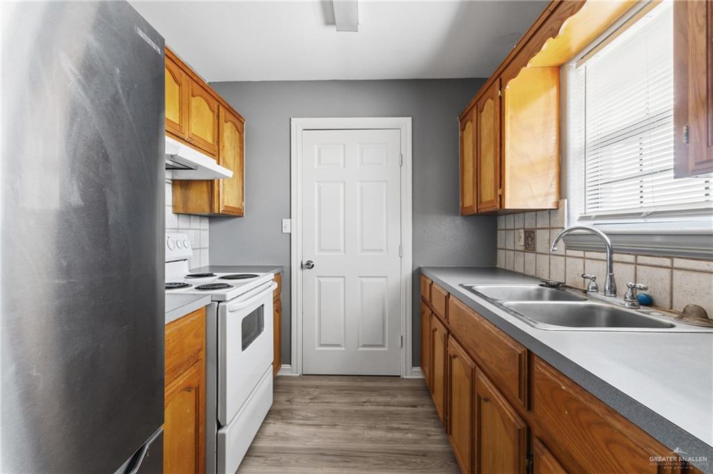 1918 Angus Street, Unit 2 Mission, TX 78572 - Photo 16 of 18 a kitchen with stainless steel appliances granite countertop a sink a stove and a refrigerator