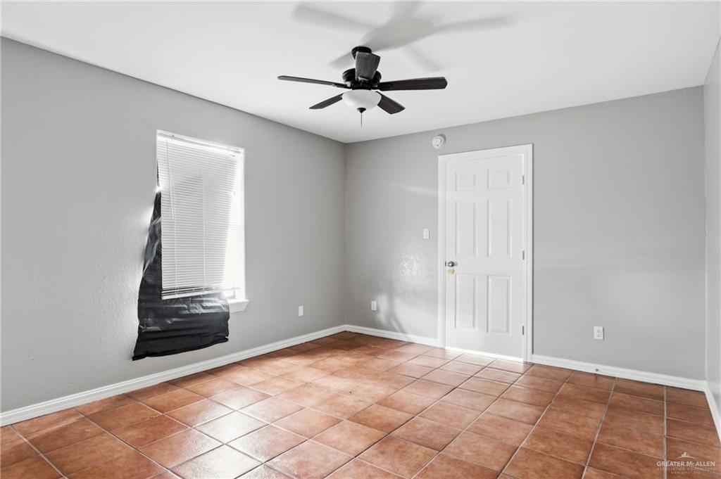 1918 Angus Street, Unit 2 Mission, TX 78572 - Photo 5 of 18 a view of an empty room with wooden floor and a ceiling fan