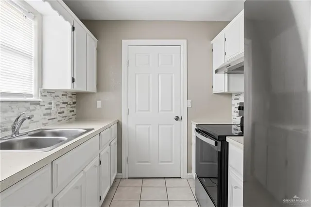a kitchen with a sink and cabinets