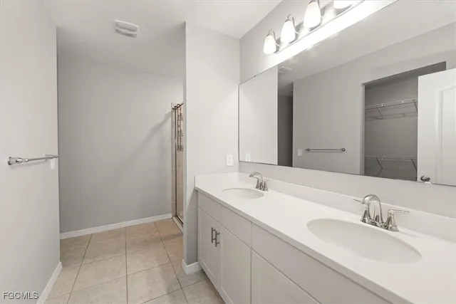 a bathroom with a double vanity sink mirror and double