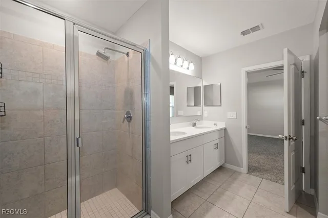 a bathroom with a shower sink and mirror