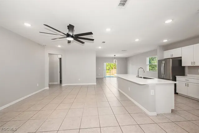 a view of kitchen with stainless steel appliances a sink and a refrigerator