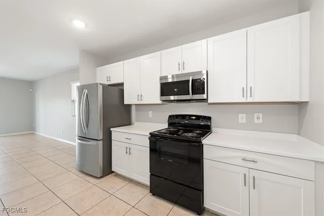 a kitchen with a sink appliances and cabinets