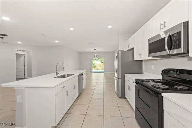 a kitchen with stainless steel appliances a stove microwave and refrigerator