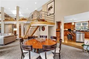 a view of a dining room with furniture and a chandelier