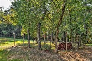 a view of a backyard with swimming pool