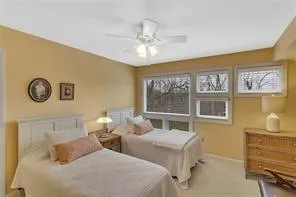 a bedroom with two beds and a window