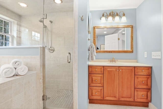 3 Summit Road Southborough, MA 01772 - Photo 17 of 41 a bathroom with a mirror a shower and a sink