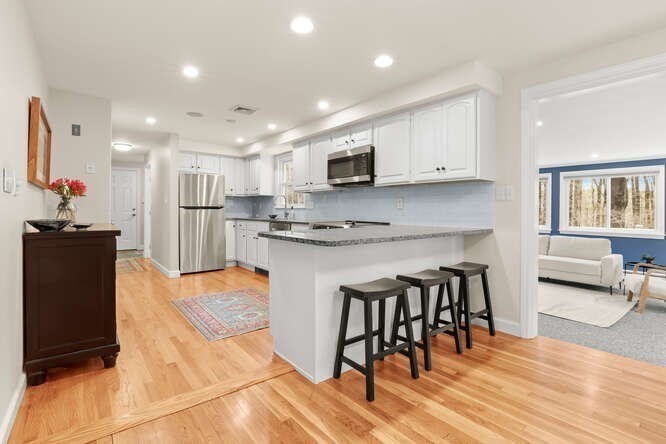 3 Summit Road Southborough, MA 01772 - Photo 8 of 41 a kitchen with stainless steel appliances kitchen island granite countertop a refrigerator and microwave