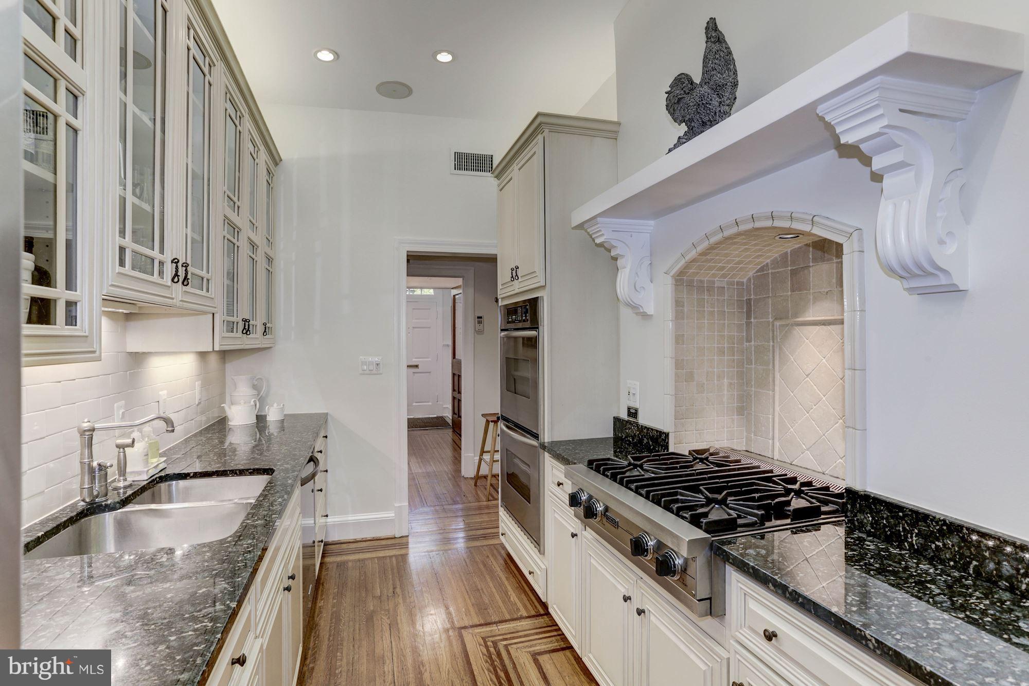 1615 21st Street Northwest Washington, DC 20009 - Photo 11 of 30 a kitchen with stainless steel appliances granite countertop a stove and a sink