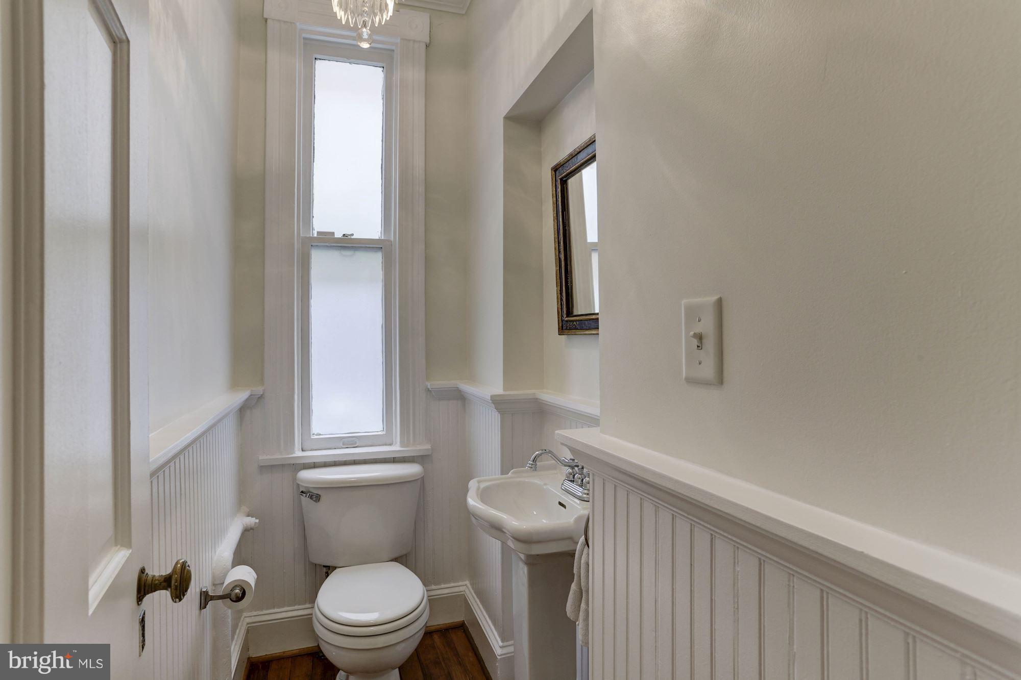 1615 21st Street Northwest Washington, DC 20009 - Photo 12 of 30 a bathroom with a toilet a sink and a window
