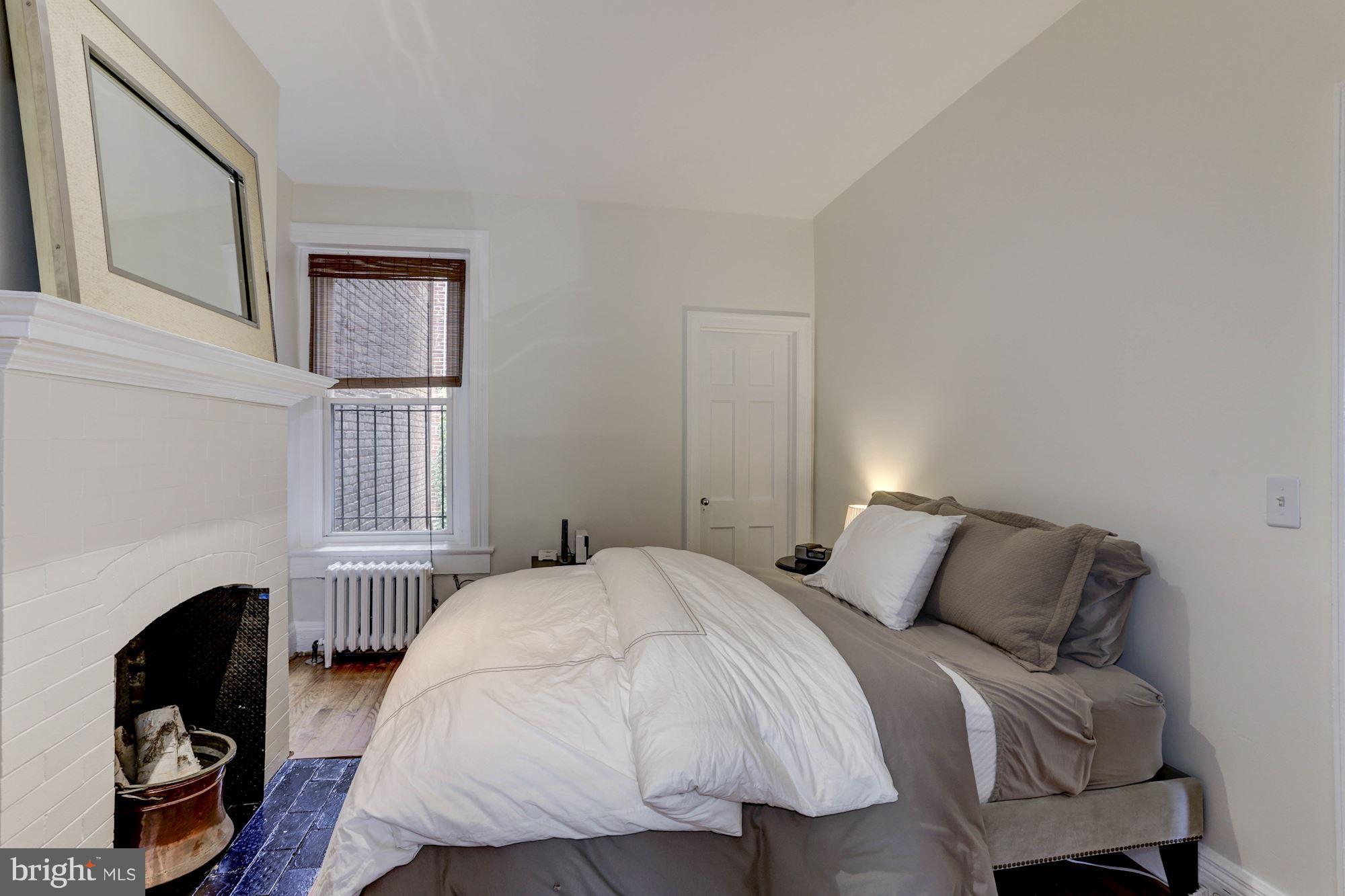 1615 21st Street Northwest Washington, DC 20009 - Photo 15 of 30 a bedroom with a bed a dresser and a window