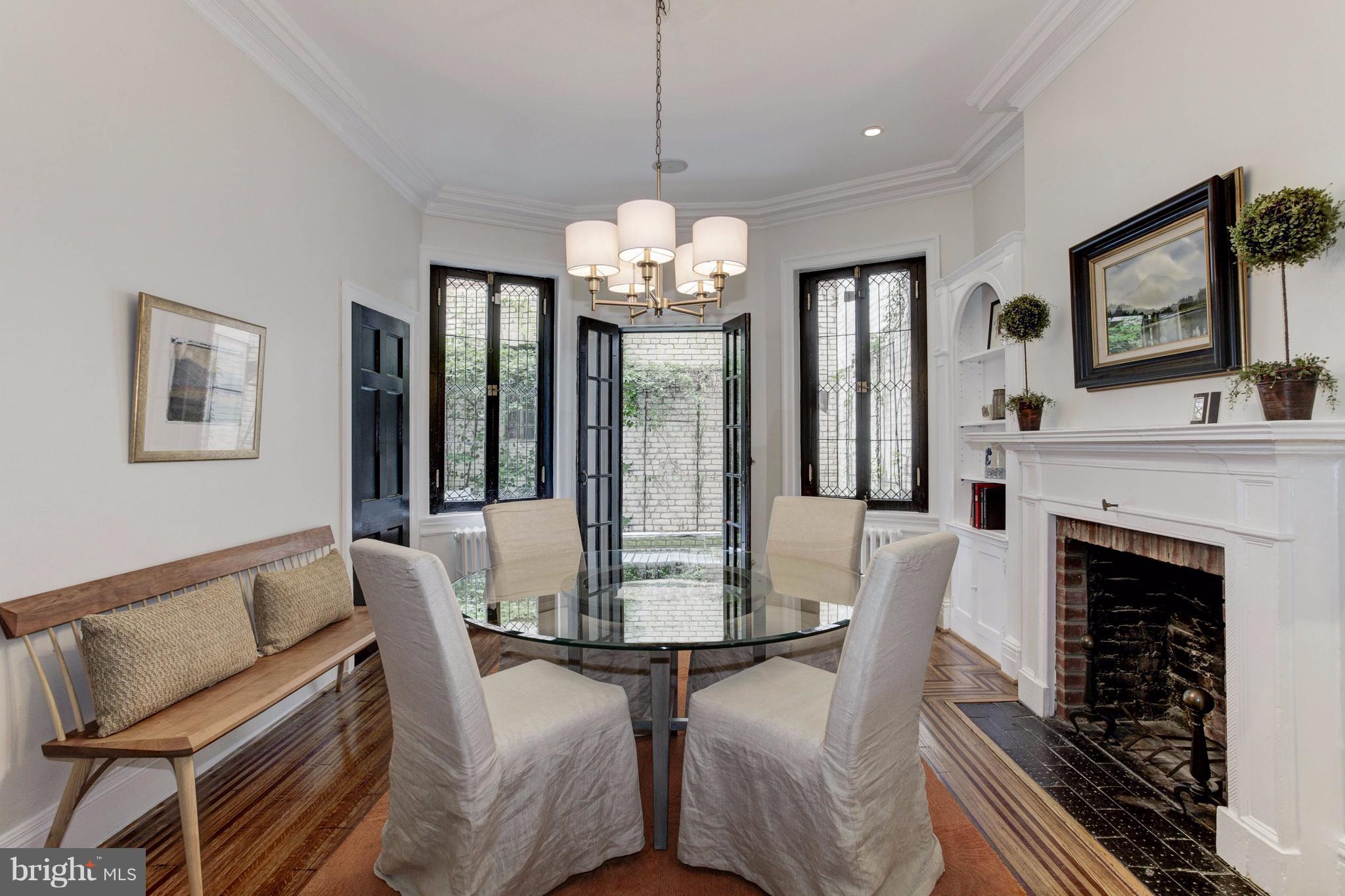 1615 21st Street Northwest Washington, DC 20009 - Photo 8 of 30 a dining room with furniture a chandelier and wooden floor