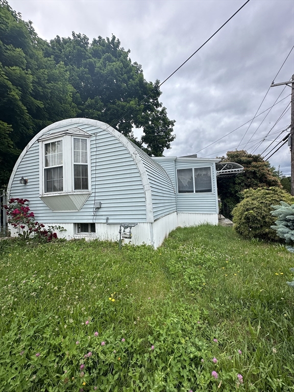 646 Rathbun Street Blackstone, MA 01504 - Photo 1 of 3 a front view of a house with a yard