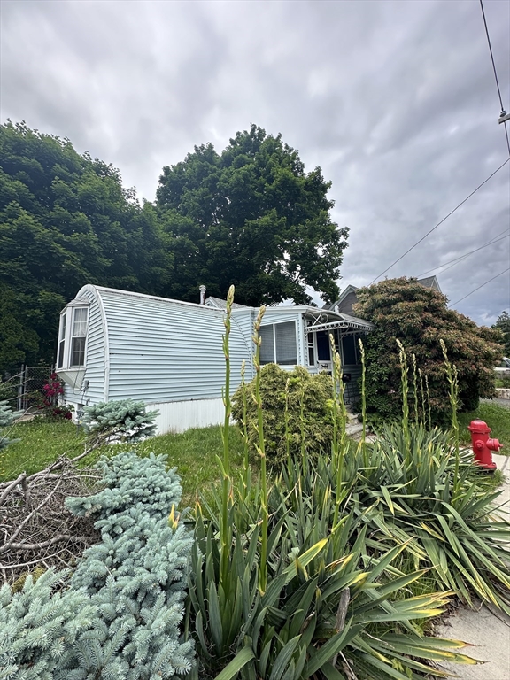 646 Rathbun Street Blackstone, MA 01504 - Photo 2 of 3 a front view of a house with a yard