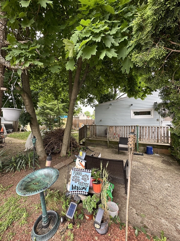646 Rathbun Street Blackstone, MA 01504 - Photo 3 of 3 a view of a patio with table and chairs potted plants and large tree