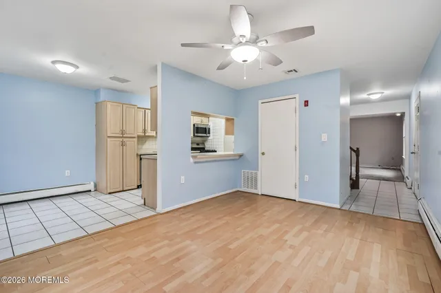 a view of a kitchen with a sink and a refrigerator
