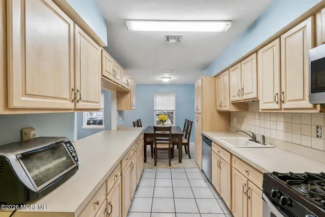 a kitchen with stainless steel appliances granite countertop a sink and cabinets