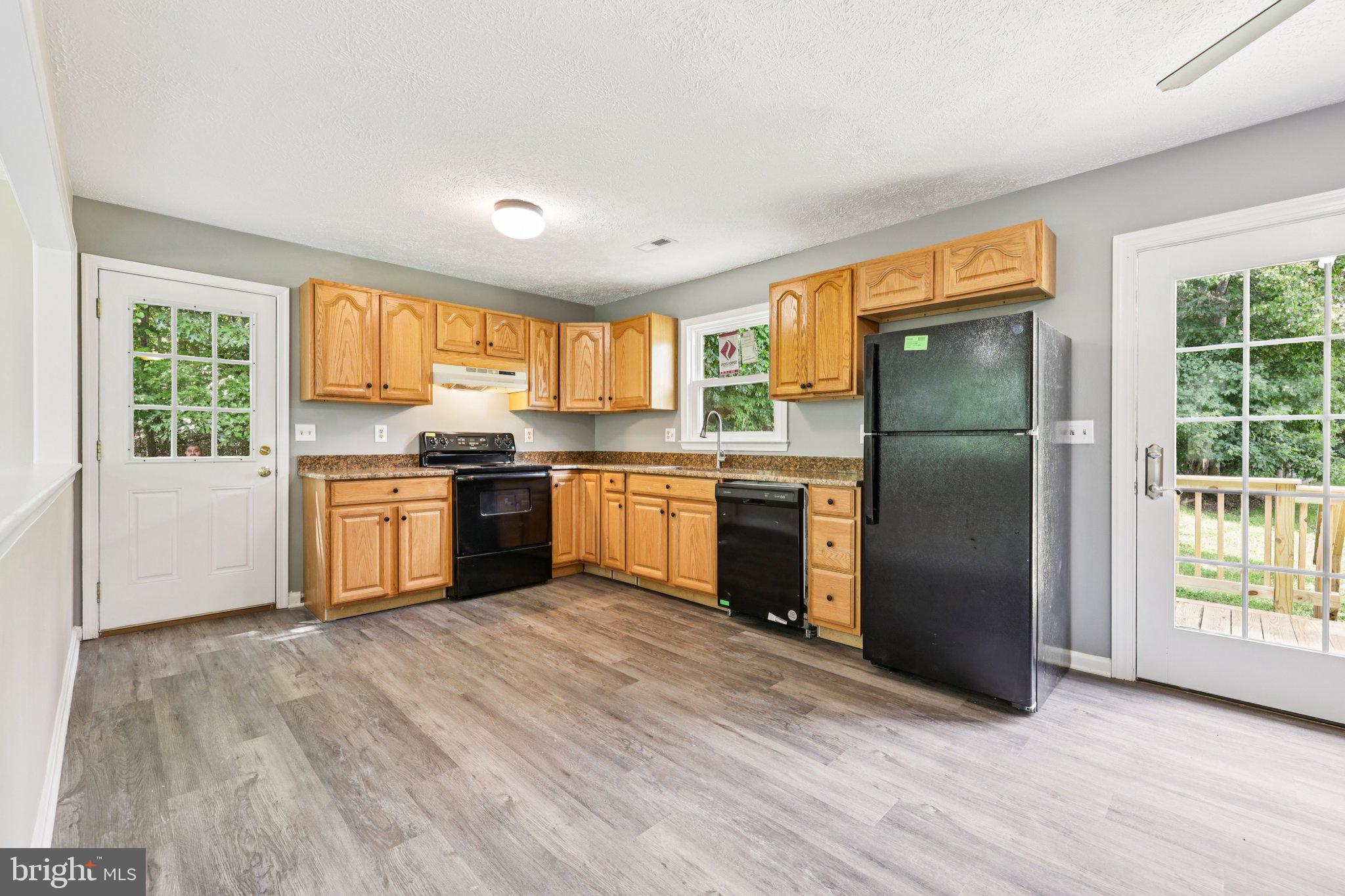 8159 Settle School Road Rixeyville, VA 22737 - Photo 13 of 16 a kitchen with a window a sink and a refrigerator