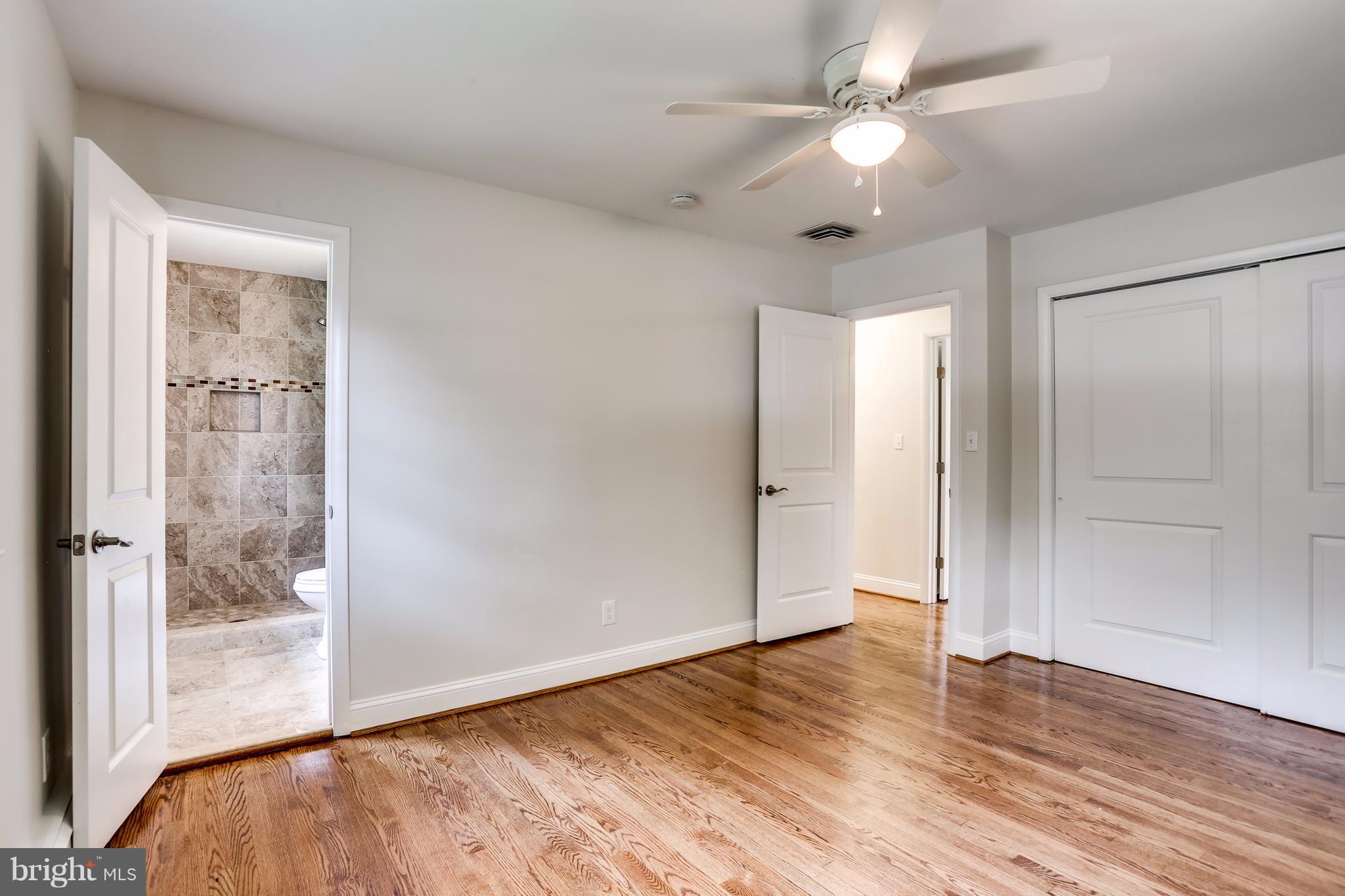 15407 Rowland Lane Silver Spring, MD 20905 - Photo 16 of 29 an empty room with wooden floor fan and windows